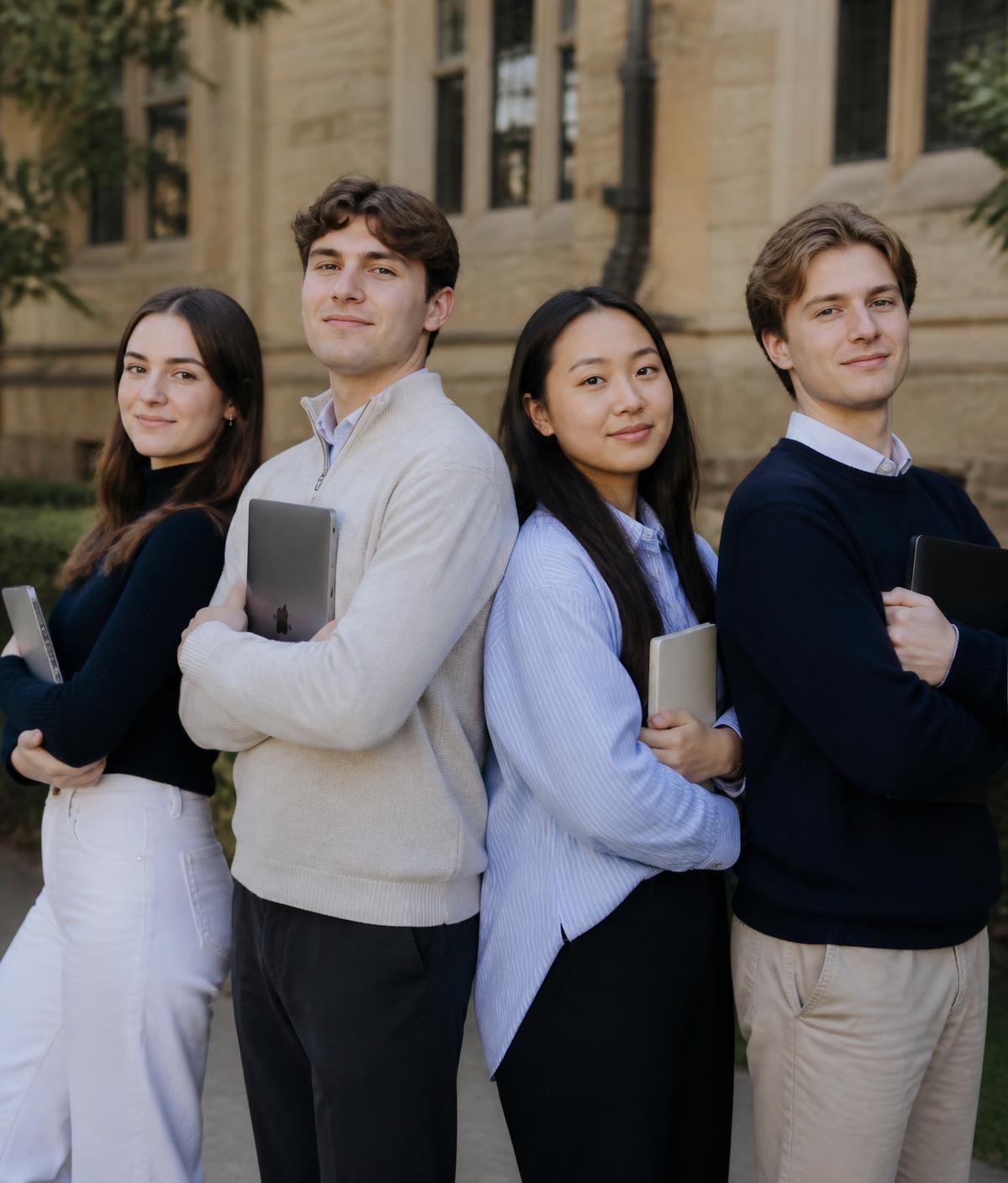 Eng Lang Pro tutors standing back to back with laptops outside a school